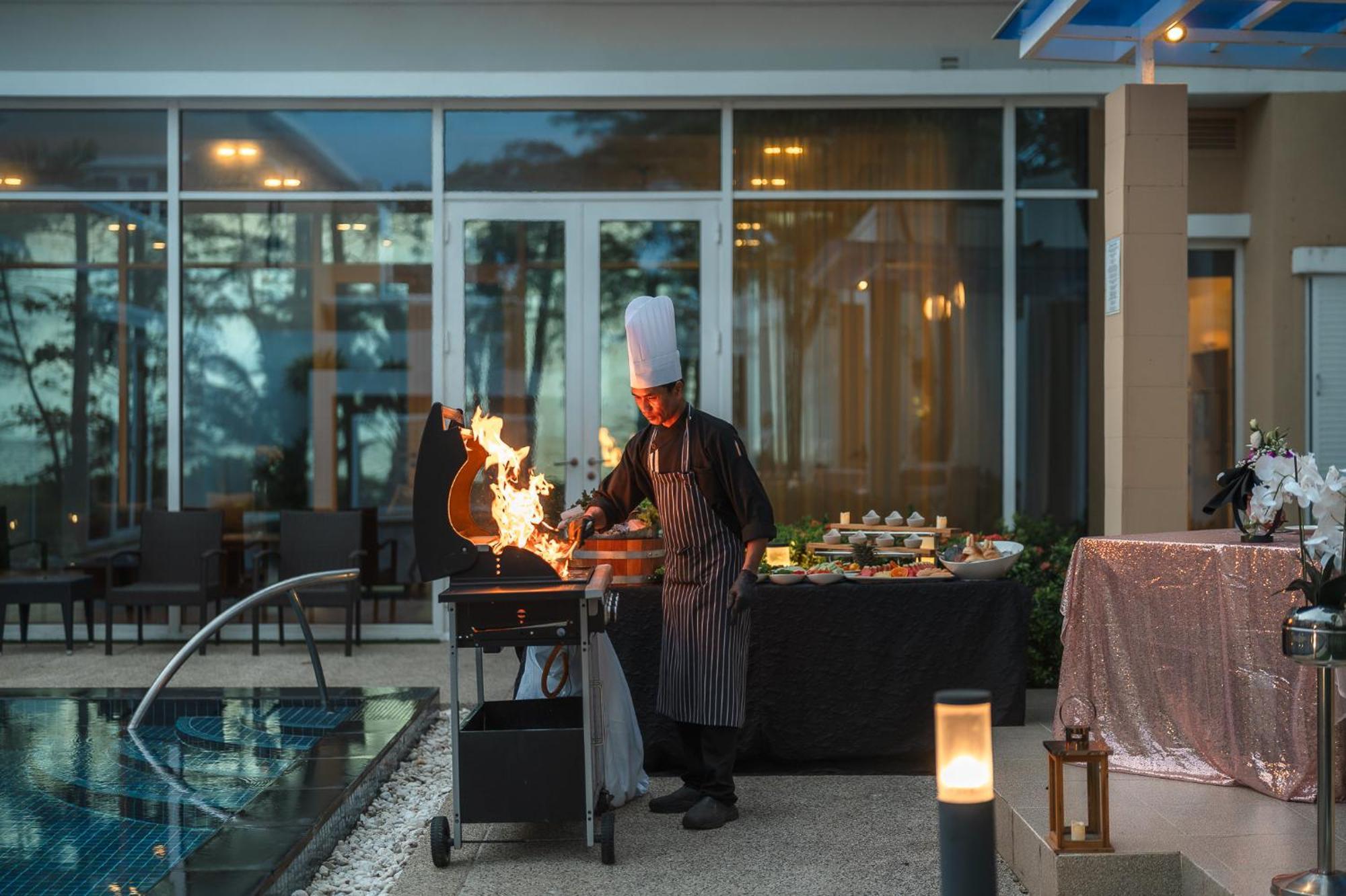 Splash Beach Resort, Maikhao Phuket - Sha Extra Plus Mai Khao Ngoại thất bức ảnh A chef cooking with a blowtorch